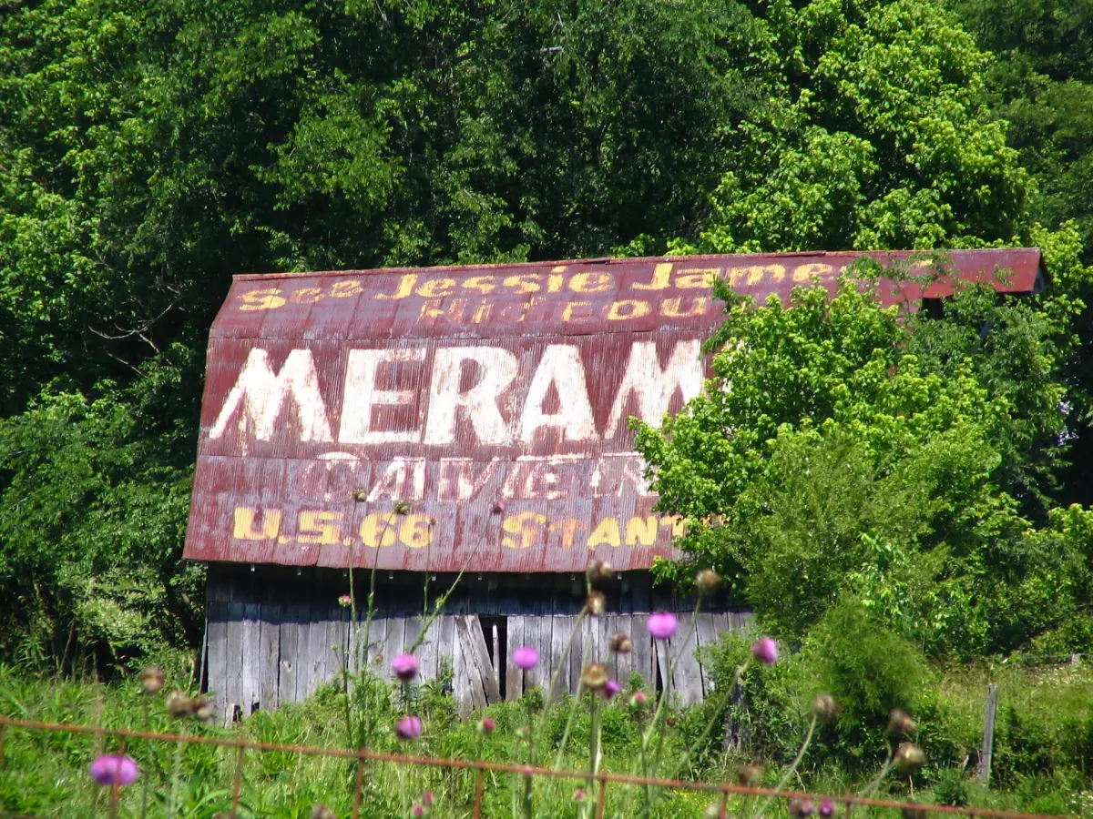 Weathered barn with a faded Meramec Caverns advertisement along U.S. Route 66