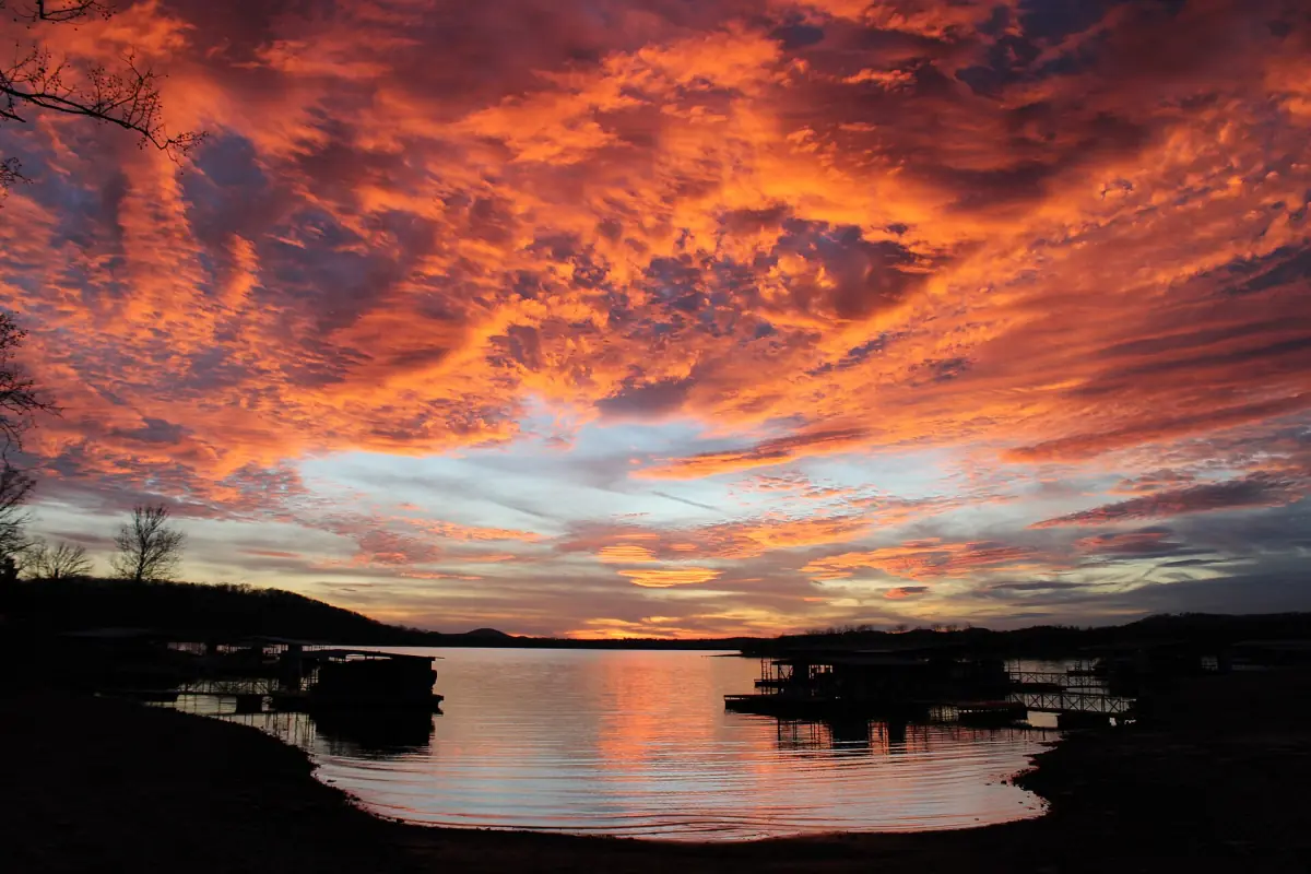 Fiery orange sunset clouds over a cove of Table Rock Lake in the Ozarks